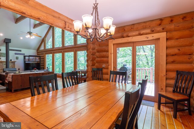 969 Hoyes Run Rd, Oakland, MD 21550 - dining area featuring rustic walls, a wood stove, light wood finished floors, a chandelier, and ceiling fan
