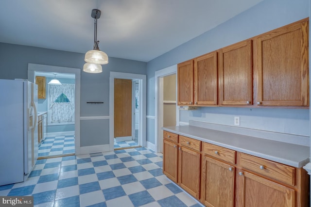 12 W Mispillion St, Harrington, DE 19952 - kitchen with white fridge with ice dispenser, light flooring, light countertops, and hanging light fixtures