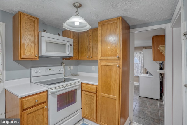 12 W Mispillion St, Harrington, DE 19952 - kitchen featuring white appliances, light countertops, a textured ceiling, washer / dryer, and decorative light fixtures
