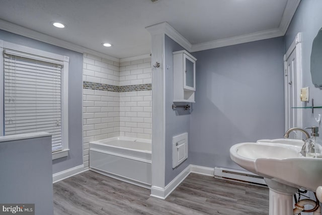 12 W Mispillion St, Harrington, DE 19952 - bathroom with ornamental molding, a baseboard heating unit, baseboards, recessed lighting, and wood finished floors