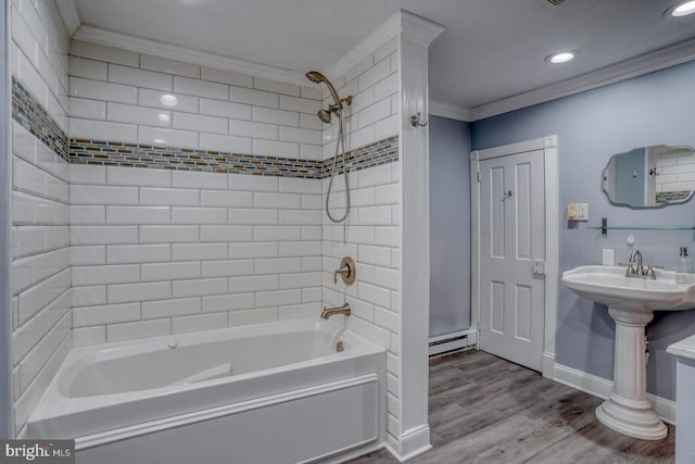 12 W Mispillion St, Harrington, DE 19952 - bathroom with ornamental molding, a baseboard heating unit, wood finished floors, recessed lighting, and bathing tub / shower combination