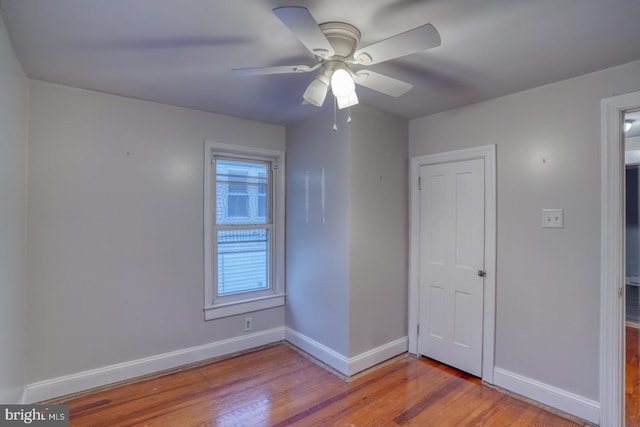 12 W Mispillion St, Harrington, DE 19952 - unfurnished bedroom with baseboards, wood finished floors, and ceiling fan