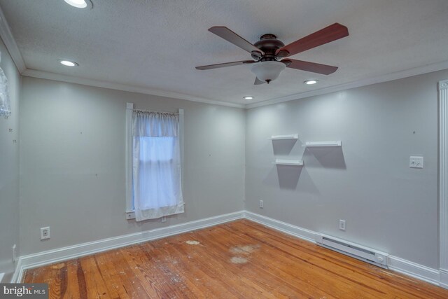 12 W Mispillion St, Harrington, DE 19952 - spare room featuring baseboard heating, a ceiling fan, ornamental molding, wood-type flooring, and recessed lighting