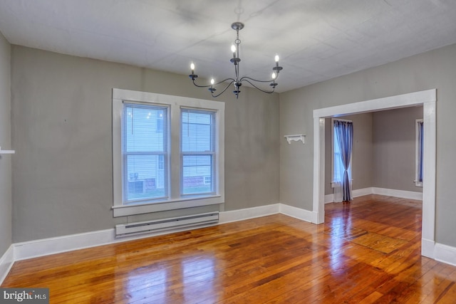 12 W Mispillion St, Harrington, DE 19952 - unfurnished room with a chandelier, wood-type flooring, a baseboard heating unit, and baseboards