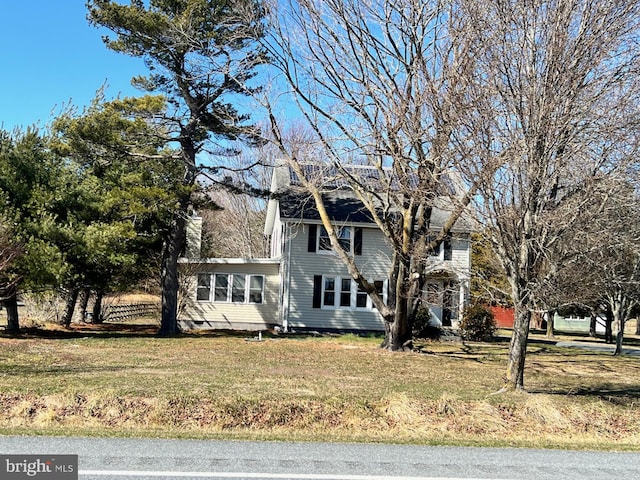 view of front of home featuring a front lawn and a chimney