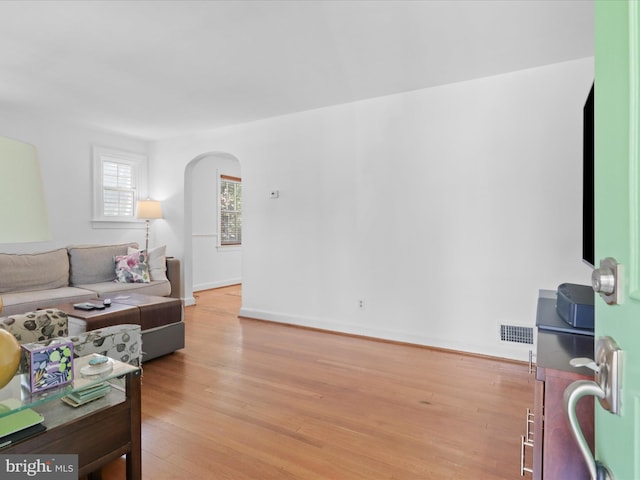 3912 13th St S, Arlington, VA 22204 - living area featuring arched walkways, light wood-style flooring, and baseboards