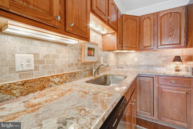 5904 Mount Eagle Dr Unit 1105, Alexandria, VA 22303 - kitchen featuring a sink, light stone counters, backsplash, brown cabinetry, and stainless steel dishwasher