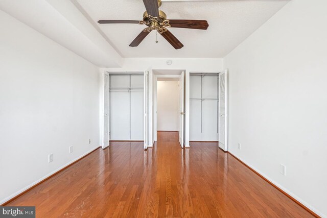 5904 Mount Eagle Dr Unit 1105, Alexandria, VA 22303 - unfurnished bedroom with baseboards, wood finished floors, a ceiling fan, and multiple closets