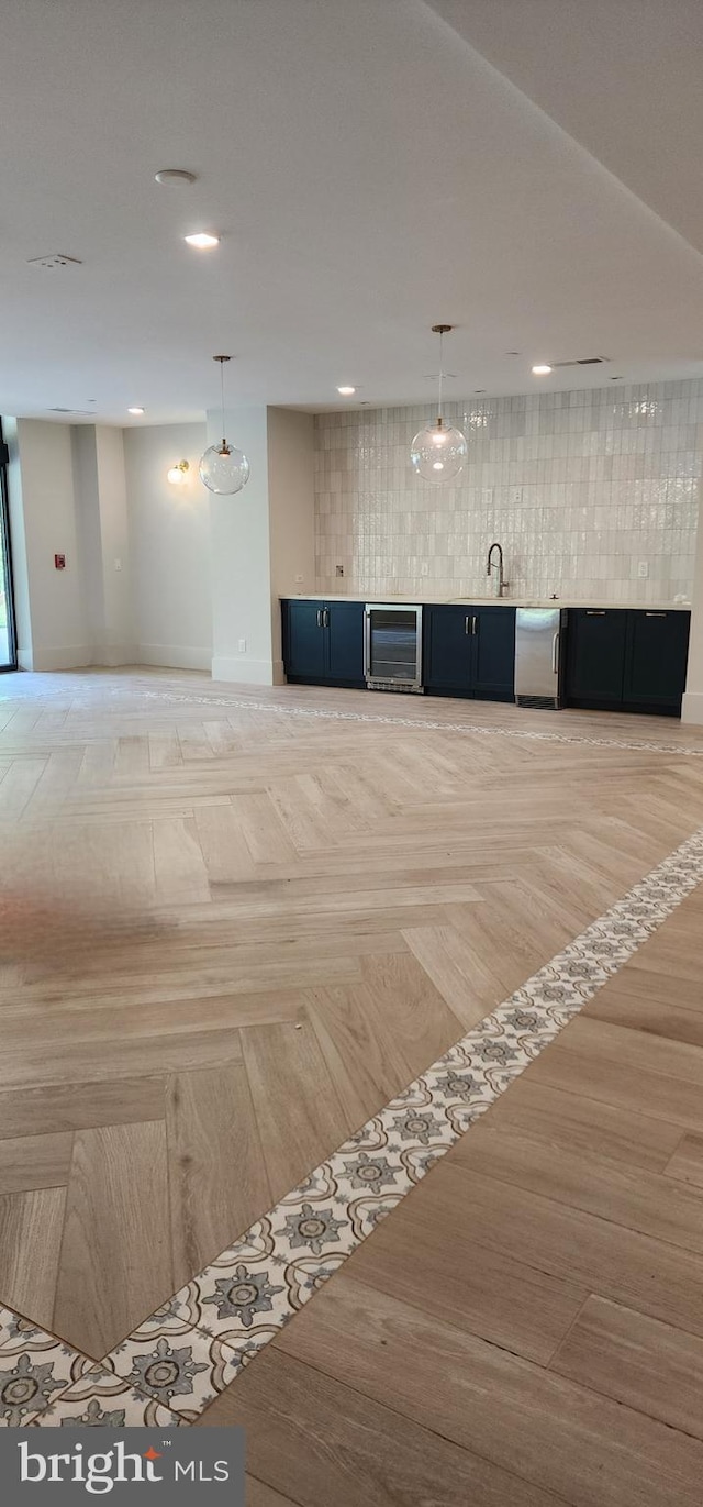 76 Old Mill Bottom Rd N Unit 309, Annapolis, MD 21409 - unfurnished living room featuring beverage cooler, recessed lighting, bar with sink, and baseboards