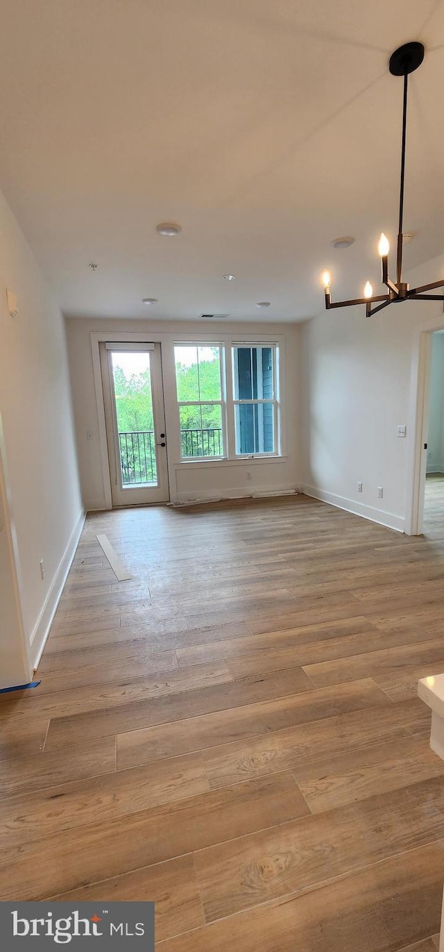 76 Old Mill Bottom Rd N Unit 309, Annapolis, MD 21409 - unfurnished room featuring wood finished floors, a chandelier, and baseboards
