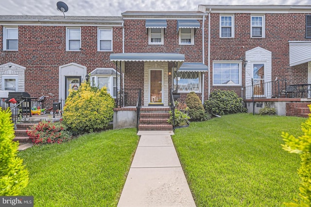 1210 Delbert Ave, Baltimore, MD 21222 - multi unit property featuring a front yard and brick siding