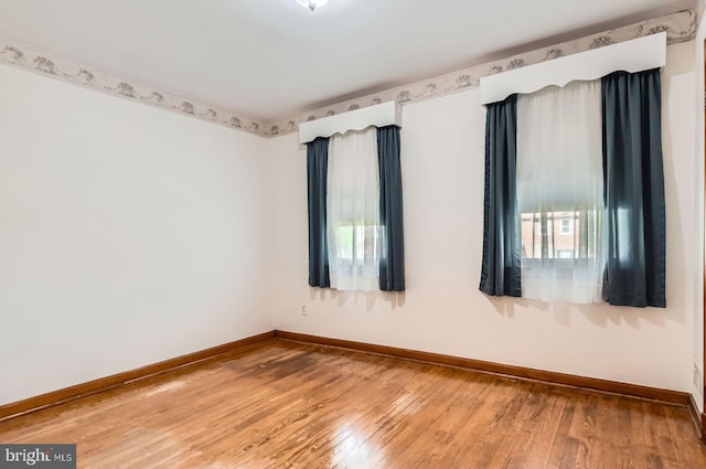 1210 Delbert Ave, Baltimore, MD 21222 - spare room with baseboards, healthy amount of natural light, and hardwood / wood-style floors