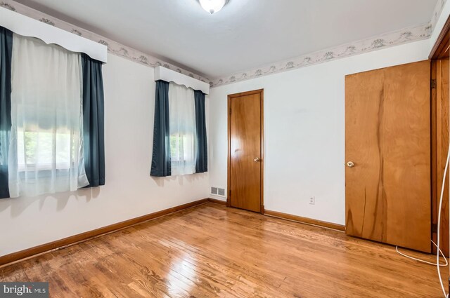 1210 Delbert Ave, Baltimore, MD 21222 - spare room with plenty of natural light, wood finished floors, and baseboards