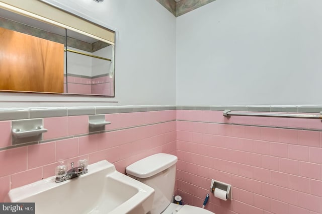 1210 Delbert Ave, Baltimore, MD 21222 - bathroom with a sink, a shower, tile walls, toilet, and a wainscoted wall