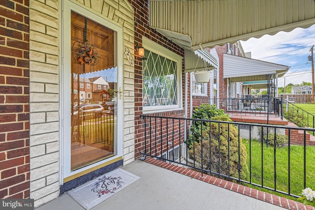 1210 Delbert Ave, Baltimore, MD 21222 - property entrance with a porch and brick siding