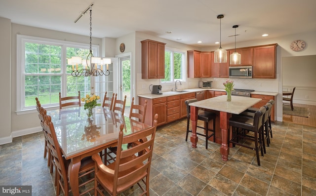 2056 Derbyshire Rd, Furlong, PA 18925 - kitchen with stainless steel microwave, a sink, decorative backsplash, baseboards, and dark stone finish floors