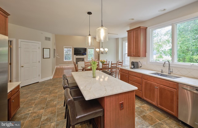 2056 Derbyshire Rd, Furlong, PA 18925 - kitchen featuring appliances with stainless steel finishes, a sink, a kitchen breakfast bar, a center island, and tasteful backsplash