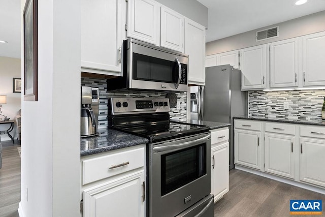 2070 Stone Rdg, Condos, Wintergreen, VA 22967 - kitchen with appliances with stainless steel finishes, dark wood-type flooring, white cabinets, decorative backsplash, and recessed lighting