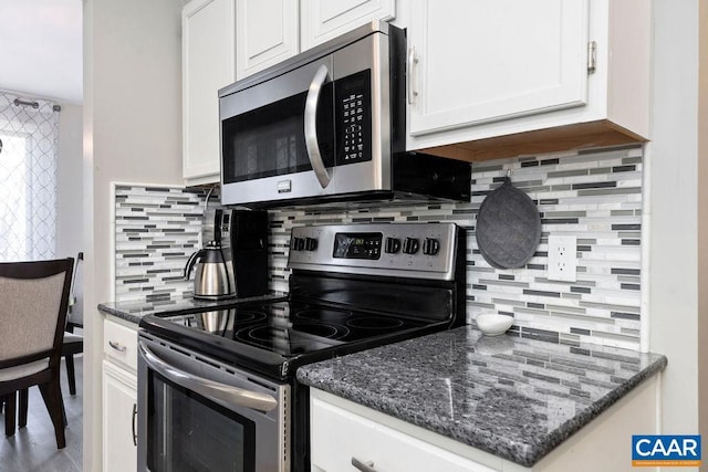 2070 Stone Rdg, Condos, Wintergreen, VA 22967 - kitchen featuring appliances with stainless steel finishes, tasteful backsplash, white cabinetry, and dark stone counters