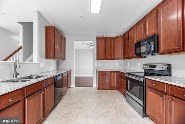 15626 Chadsey Ln, Brandywine, MD 20613 - kitchen with black appliances, a sink, ceiling fan, light stone counters, and baseboards