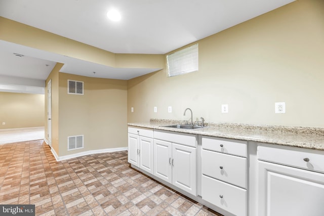15626 Chadsey Ln, Brandywine, MD 20613 - kitchen with a sink, baseboards, brick patterned flooring, and white cabinetry