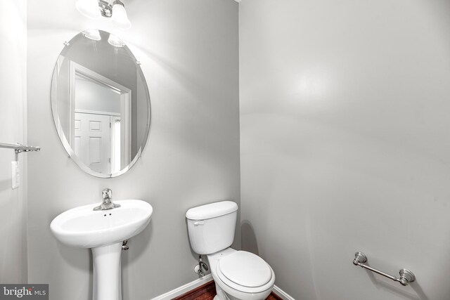 15626 Chadsey Ln, Brandywine, MD 20613 - half bathroom featuring toilet, baseboards, and a sink