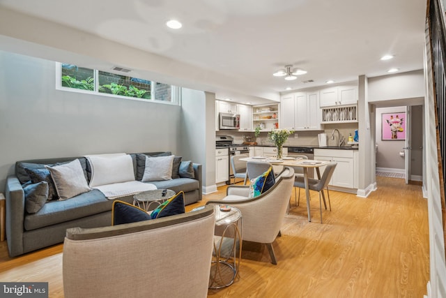 403 S Alder St, Philadelphia, PA 19147 - living area with light wood-type flooring, recessed lighting, and baseboards