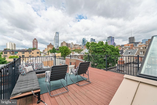 403 S Alder St, Philadelphia, PA 19147 - wooden deck featuring a view of skyline and an outdoor living space