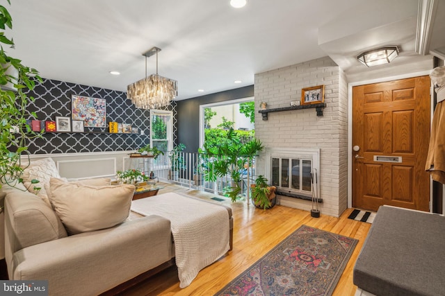 403 S Alder St, Philadelphia, PA 19147 - living area with wood finished floors, a chandelier, a brick fireplace, and recessed lighting