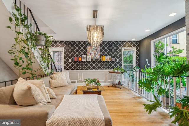 403 S Alder St, Philadelphia, PA 19147 - living area featuring wood finished floors, a chandelier, an accent wall, and recessed lighting