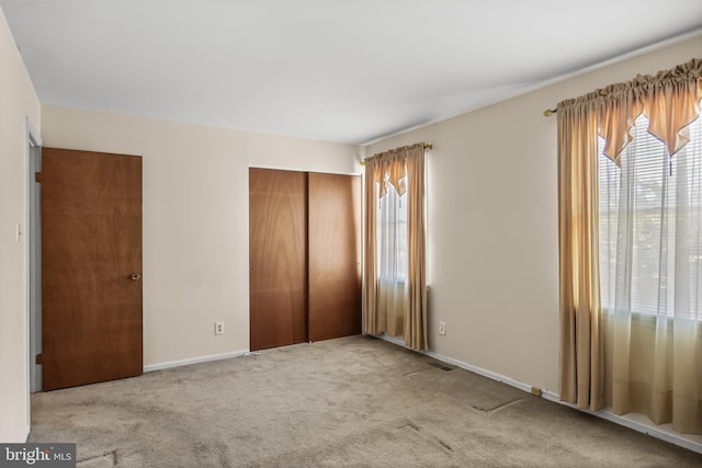 2428 Pliner Ct, Atco, NJ 08004 - unfurnished bedroom featuring multiple windows, a closet, carpet floors, and baseboards