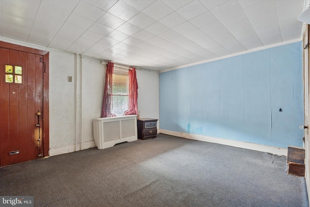 carpeted empty room featuring baseboards