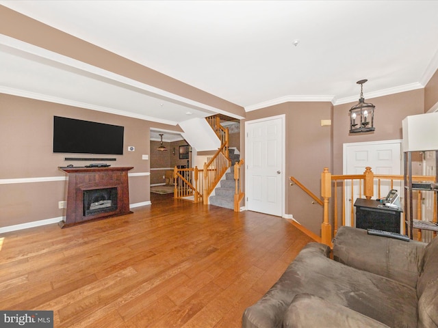 5500 Upshur Sq, Frederick, MD 21703 - living area featuring baseboards, crown molding, light wood finished floors, a fireplace, and stairway