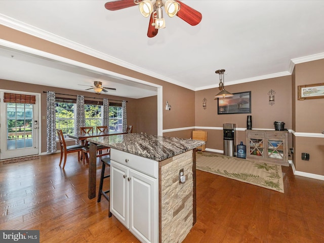 5500 Upshur Sq, Frederick, MD 21703 - kitchen featuring ceiling fan, baseboards, a center island, wood finished floors, and ornamental molding