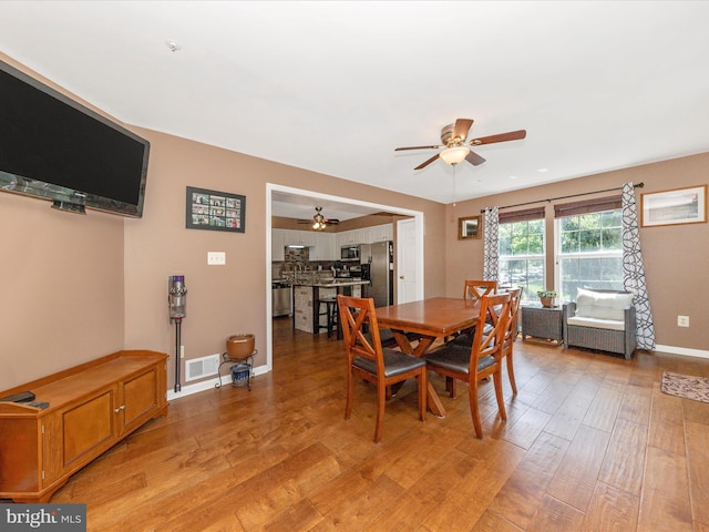 5500 Upshur Sq, Frederick, MD 21703 - dining room featuring a ceiling fan, light wood-style floors, and baseboards