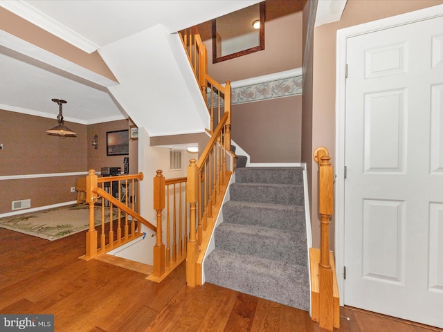 5500 Upshur Sq, Frederick, MD 21703 - stairway with wood finished floors, crown molding, and baseboards