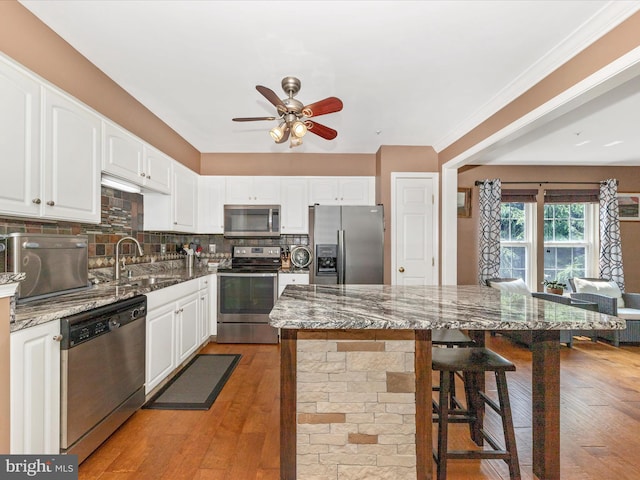 5500 Upshur Sq, Frederick, MD 21703 - kitchen with appliances with stainless steel finishes, a sink, a ceiling fan, dark stone countertops, and decorative backsplash