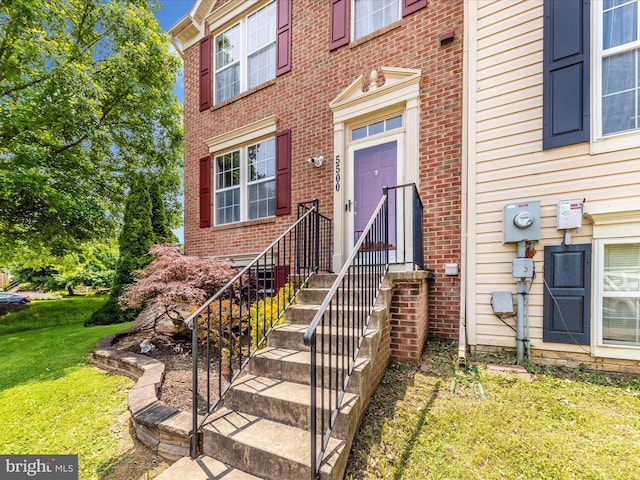 5500 Upshur Sq, Frederick, MD 21703 - view of exterior entry featuring a lawn and brick siding