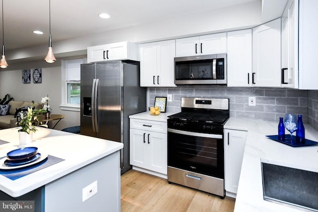 711 57th Pl NE, Washington, DC 20019 - kitchen with stainless steel appliances, light countertops, white cabinets, light wood-type flooring, and recessed lighting