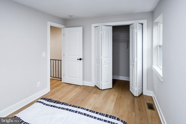 711 57th Pl NE, Washington, DC 20019 - unfurnished bedroom with wood finished floors, baseboards, and a closet