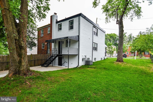 711 57th Pl NE, Washington, DC 20019 - rear view of house with a chimney, stairway, a patio, and brick siding