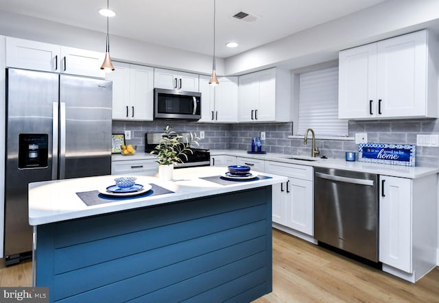 711 57th Pl NE, Washington, DC 20019 - kitchen featuring stainless steel appliances, a sink, white cabinets, light countertops, and recessed lighting