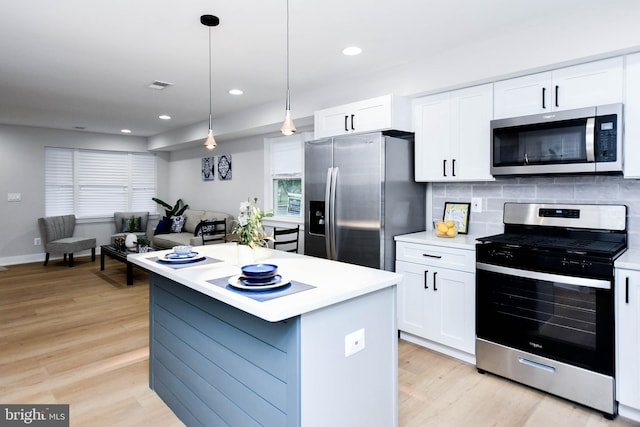 711 57th Pl NE, Washington, DC 20019 - kitchen featuring stainless steel appliances, light countertops, light wood-type flooring, white cabinets, and recessed lighting