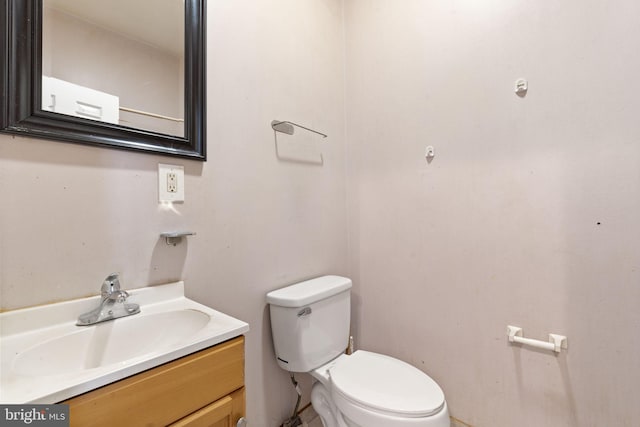 half bath featuring toilet and vanity