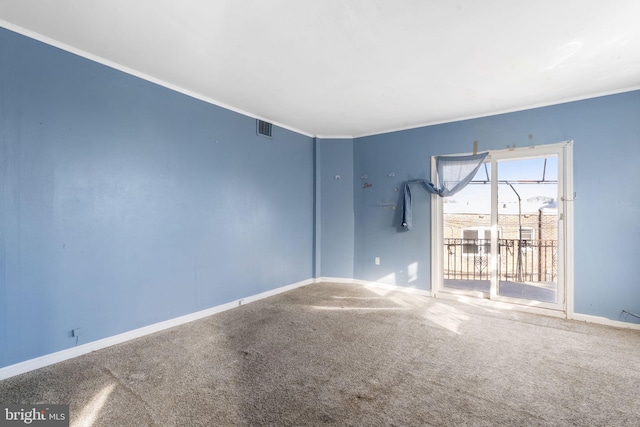 carpeted spare room with crown molding and baseboards