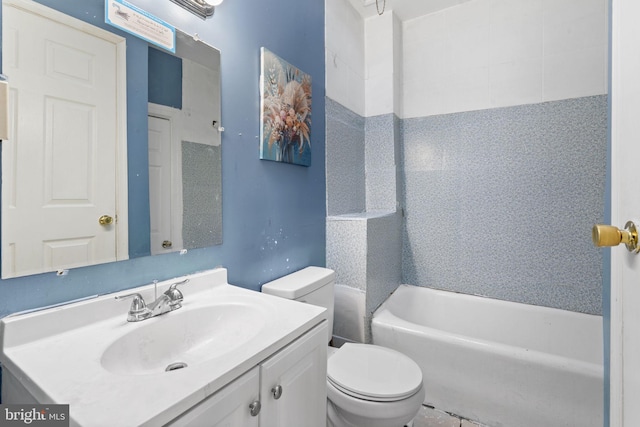 bathroom featuring toilet, a tub to relax in, and vanity