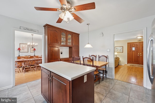 1 Locust Ln, Media, PA 19063 - kitchen featuring light tile patterned floors, a ceiling fan, hanging light fixtures, a kitchen island, and glass insert cabinets
