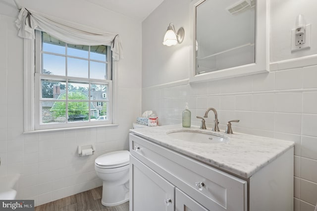 1 Locust Ln, Media, PA 19063 - bathroom with tile walls, healthy amount of natural light, vanity, wood finished floors, and toilet