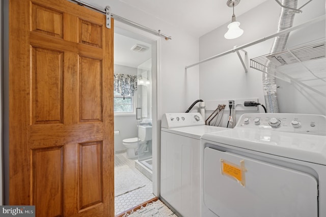1 Locust Ln, Media, PA 19063 - washroom featuring separate washer and dryer, tile patterned flooring, and a barn door