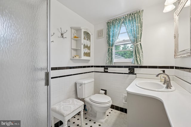 1 Locust Ln, Media, PA 19063 - full bathroom featuring toilet, wainscoting, vanity, tile walls, and a stall shower